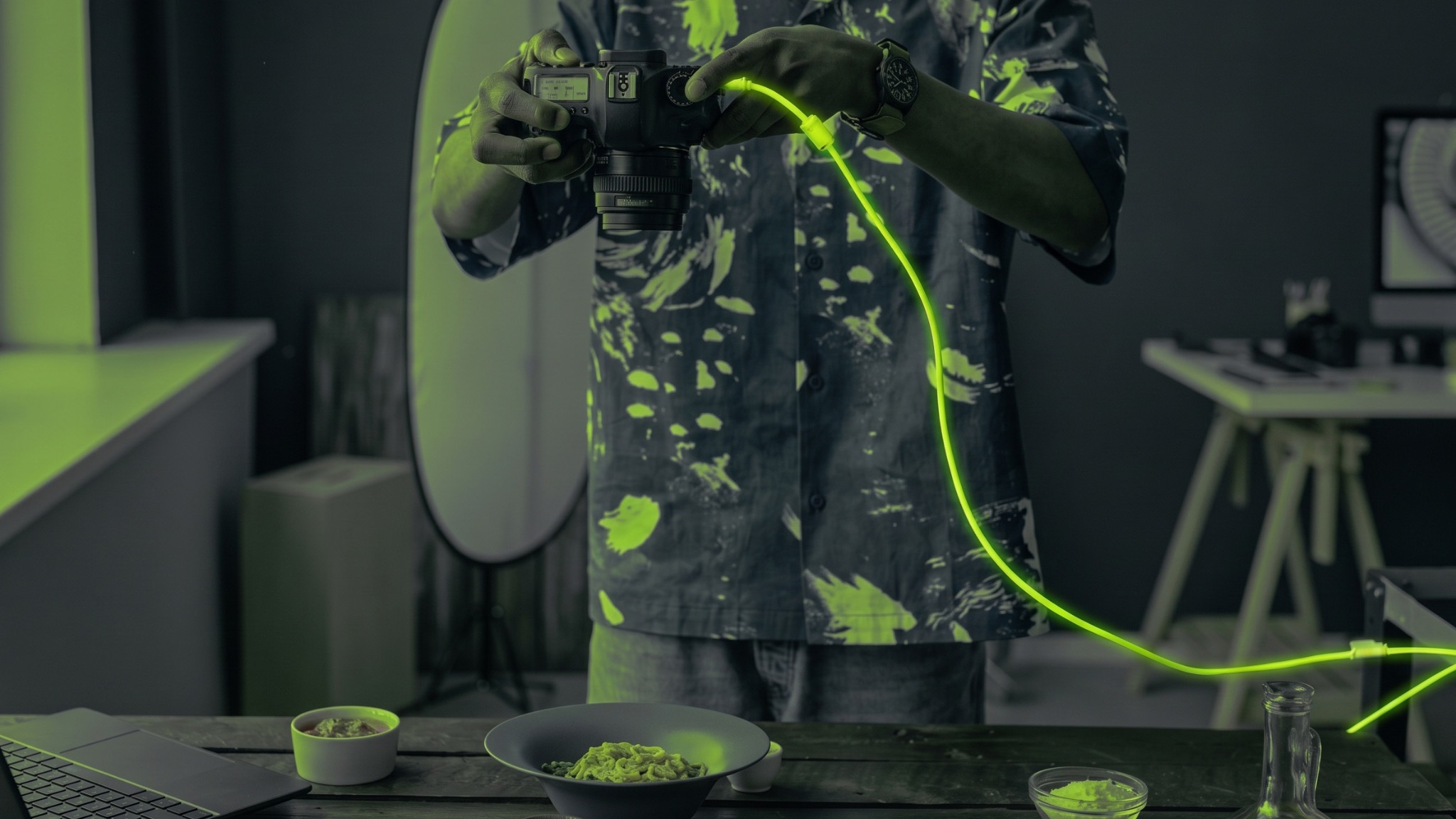 Photographer capturing a food product with a camera and lime tether cable